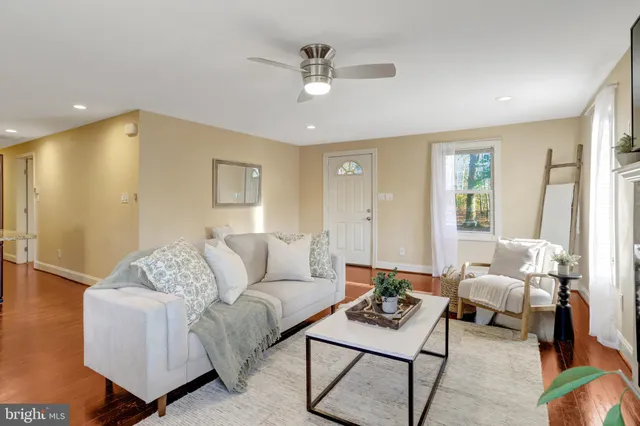 a living room with furniture and a ceiling fan