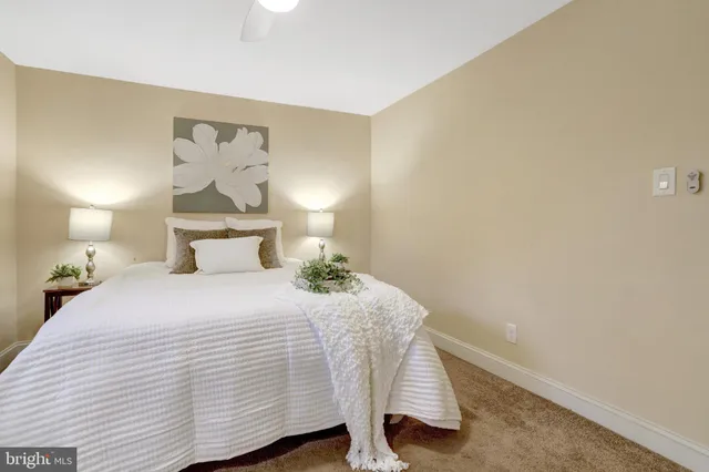 a bedroom with a bed and painting on the wall