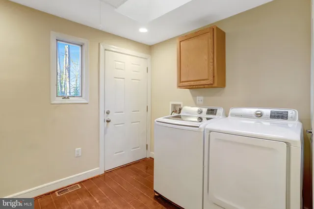 a kitchen with stainless steel appliances granite countertop a sink a stove and cabinets