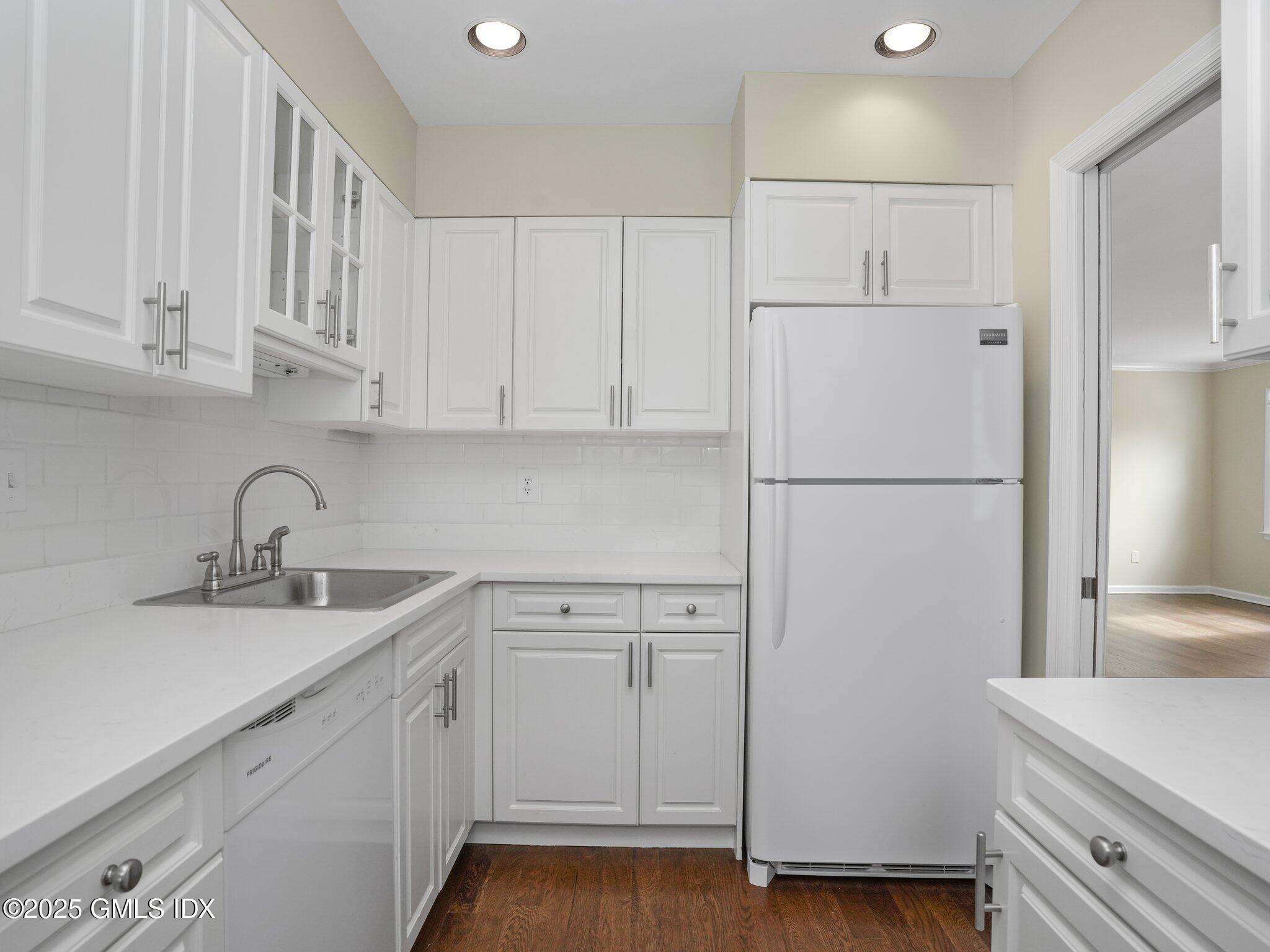 102 Valley Road, Unit 23 Cos Cob, CT 06807 - Photo 4 of 13 a kitchen with cabinets appliances and a sink
