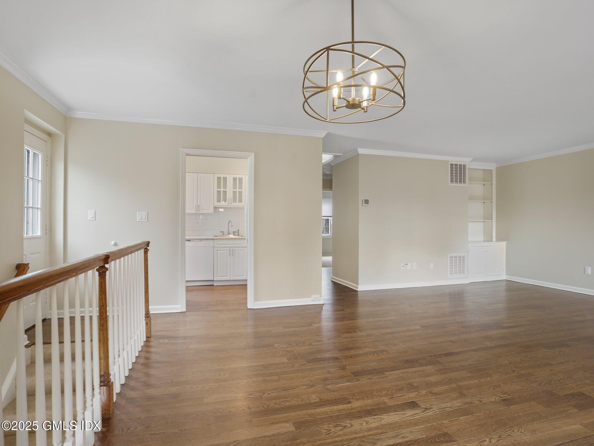 102 Valley Road, Unit 23 Cos Cob, CT 06807 - Photo 6 of 13 a view of an empty room with wooden floor and windows