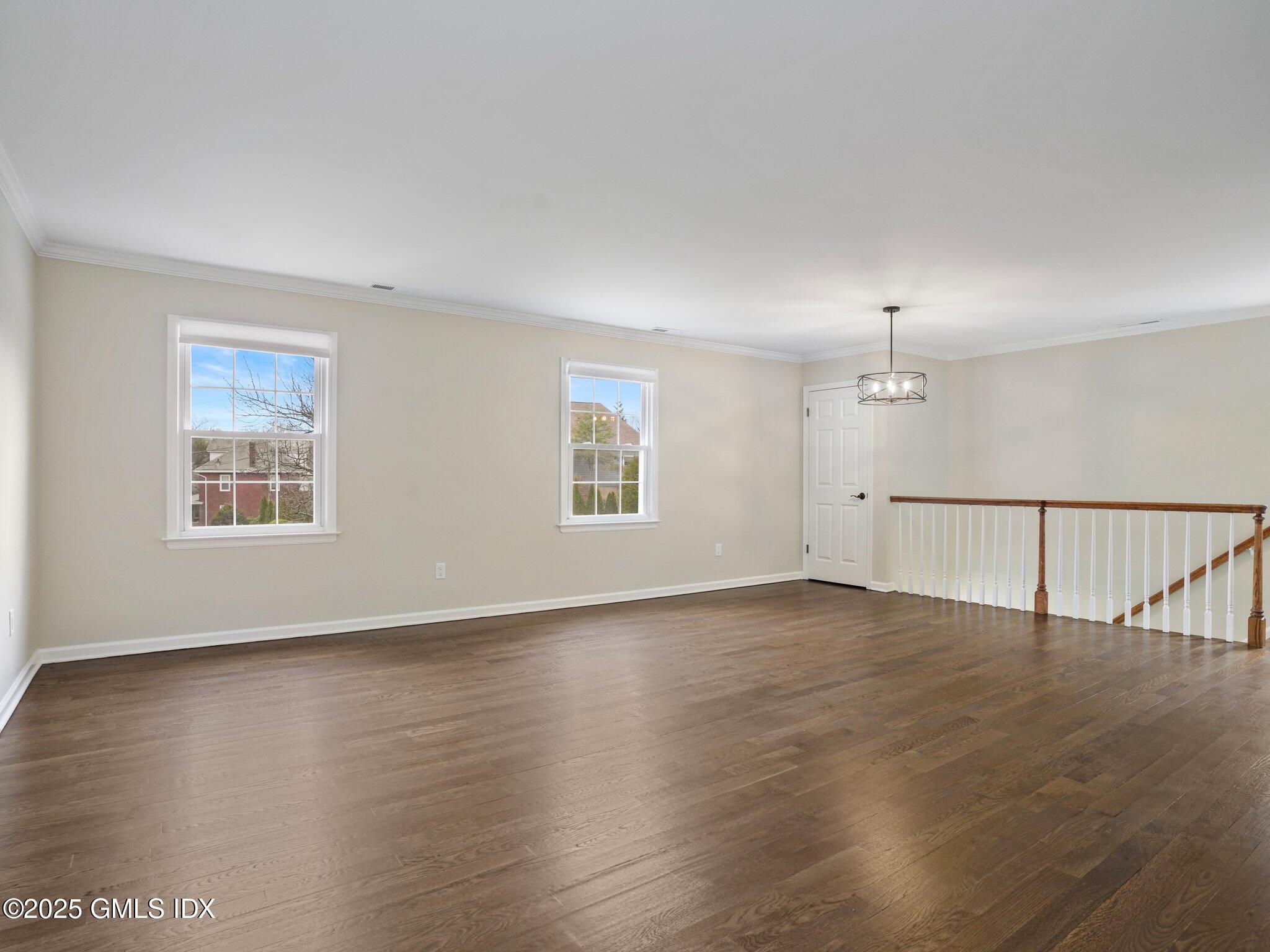 102 Valley Road, Unit 23 Cos Cob, CT 06807 - Photo 7 of 13 a view of an empty room with wooden floor and a window