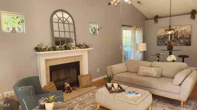 a living room with furniture a fireplace and window