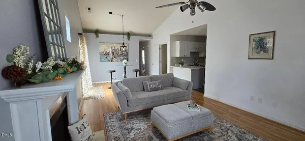 a living room with furniture and a chandelier