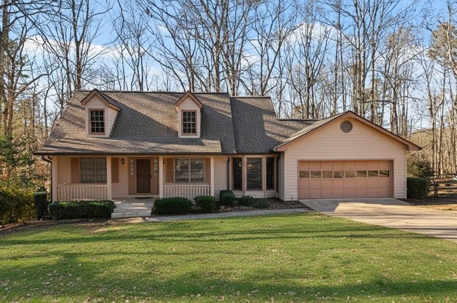 a front view of a house with a garden and trees
