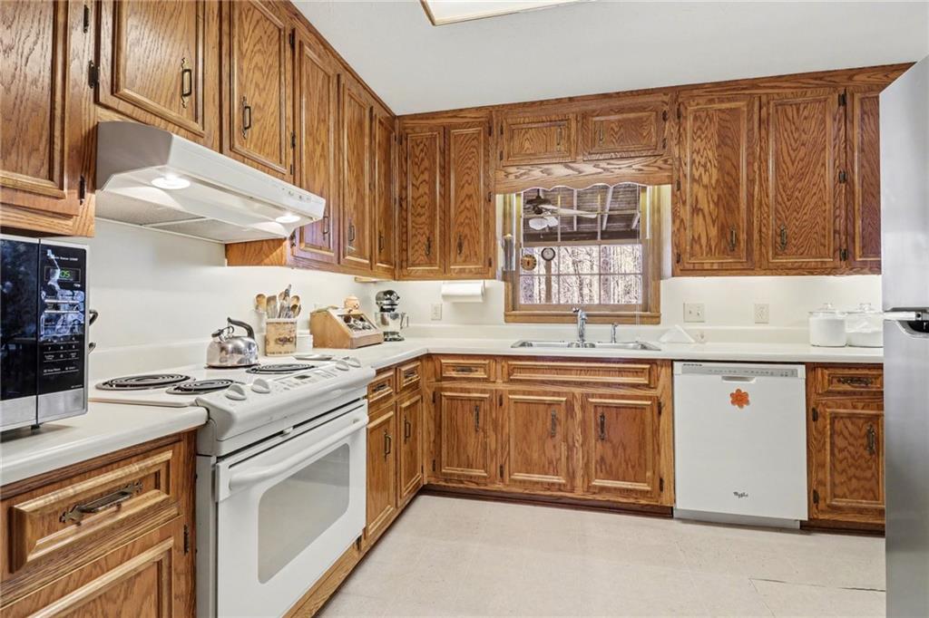 1940 Commonwealth Court Cumming, GA 30041 - Photo 11 of 29 a kitchen with stainless steel appliances granite countertop a sink stove and cabinets