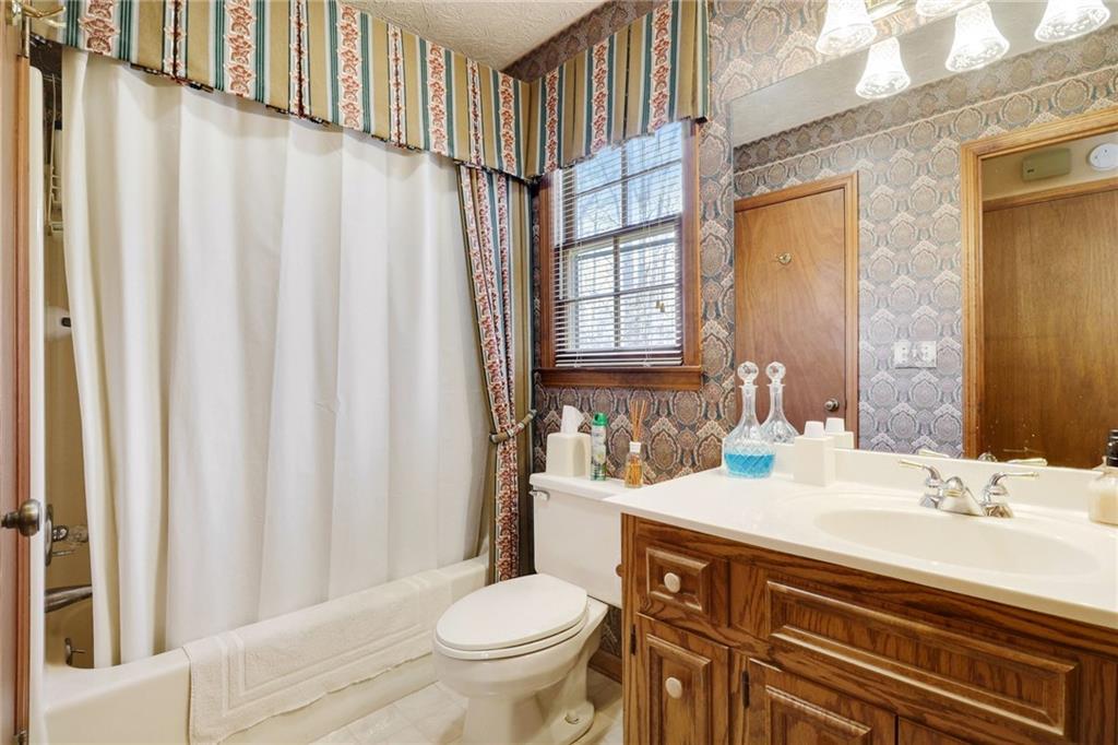 1940 Commonwealth Court Cumming, GA 30041 - Photo 17 of 29 a bathroom with a sink toilet and shower