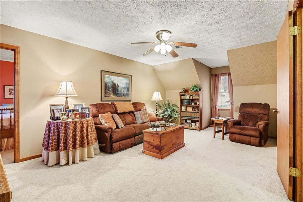 1940 Commonwealth Court Cumming, GA 30041 - Photo 19 of 29 a living room with furniture ceiling fan and a lamp
