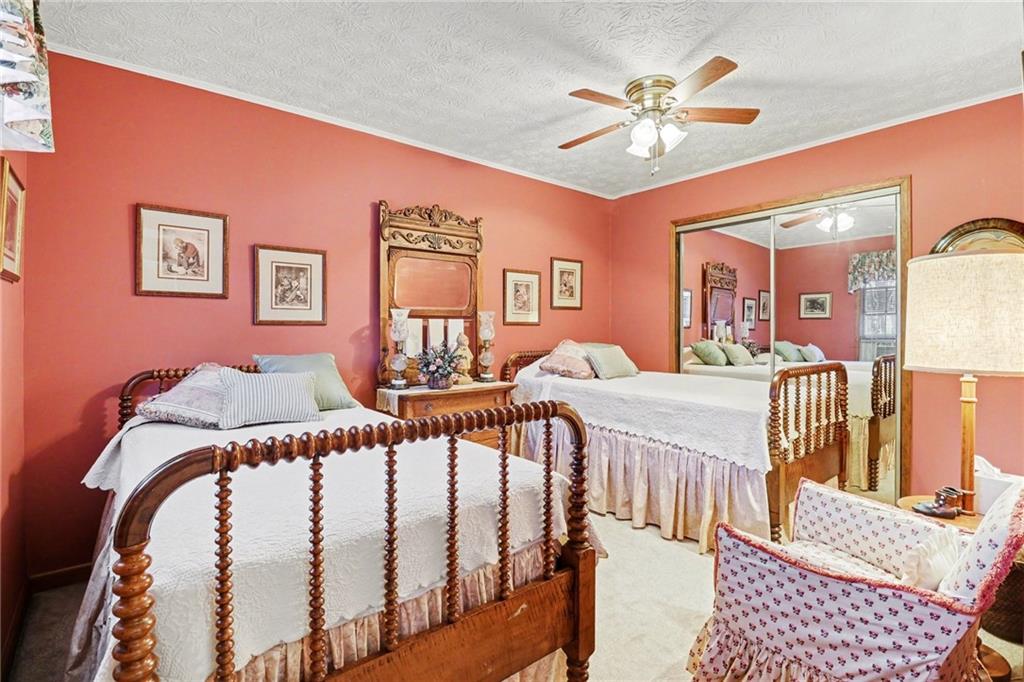 1940 Commonwealth Court Cumming, GA 30041 - Photo 21 of 29 a bedroom with furniture and a chandelier