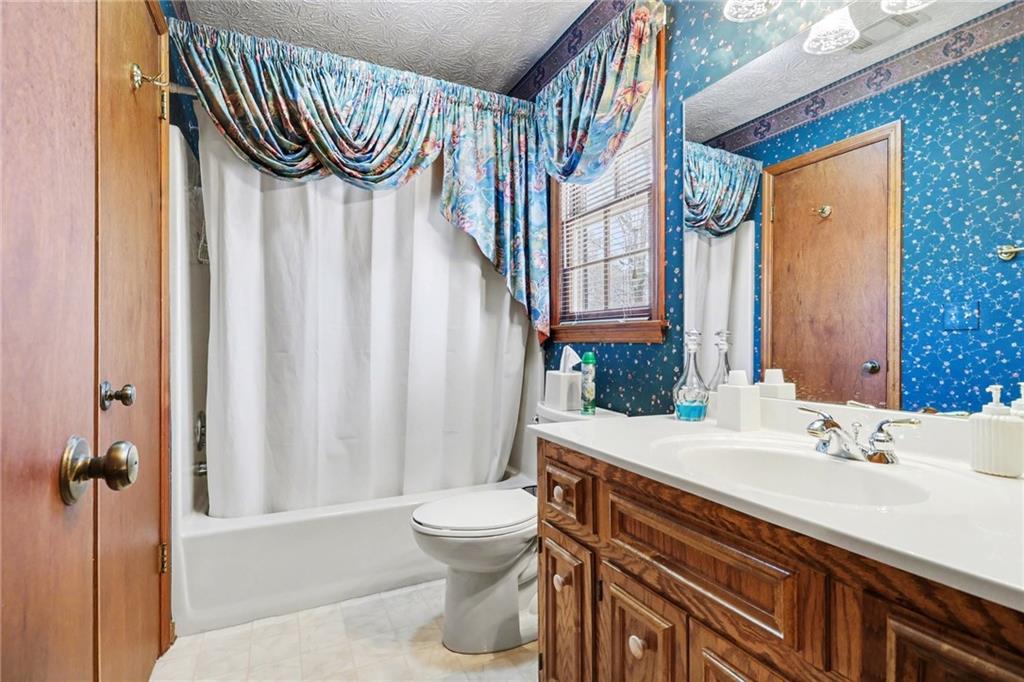 1940 Commonwealth Court Cumming, GA 30041 - Photo 23 of 29 a bathroom with a sink a toilet and a mirror