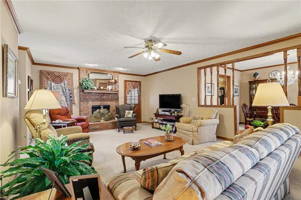 1940 Commonwealth Court Cumming, GA 30041 - Photo 3 of 29 a living room with furniture a large window and a flat screen tv