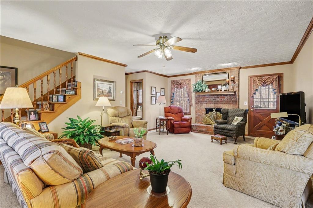 1940 Commonwealth Court Cumming, GA 30041 - Photo 5 of 29 a living room with furniture ceiling fan and a rug