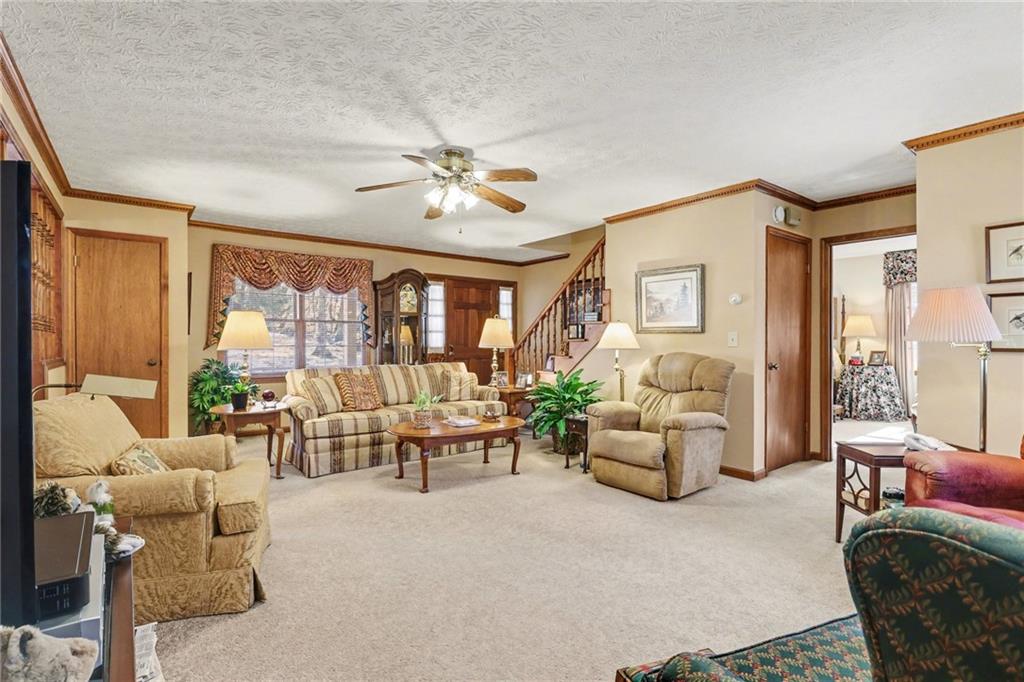 1940 Commonwealth Court Cumming, GA 30041 - Photo 6 of 29 a living room with furniture ceiling fan and a window
