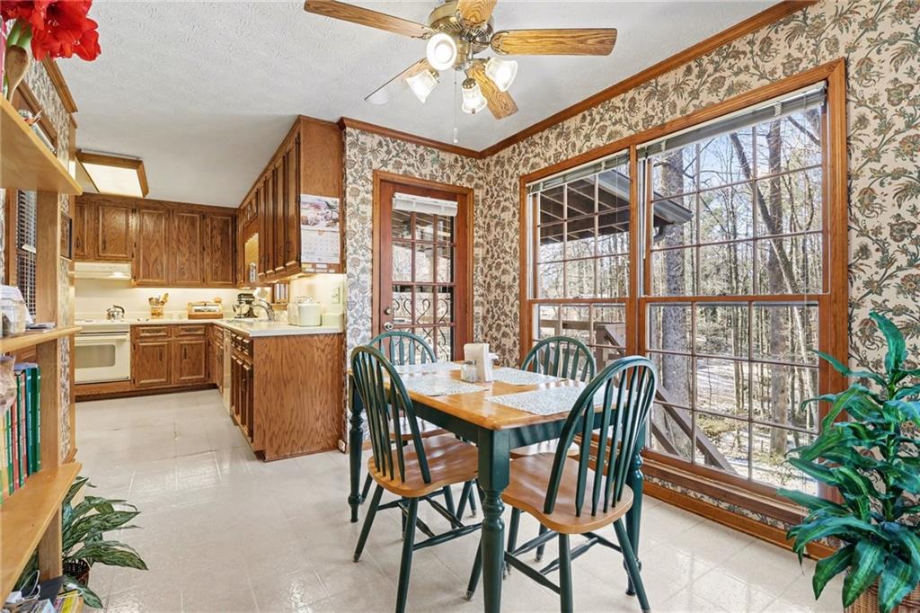 1940 Commonwealth Court Cumming, GA 30041 - Photo 7 of 29 a dining room with furniture a chandelier and wooden floor