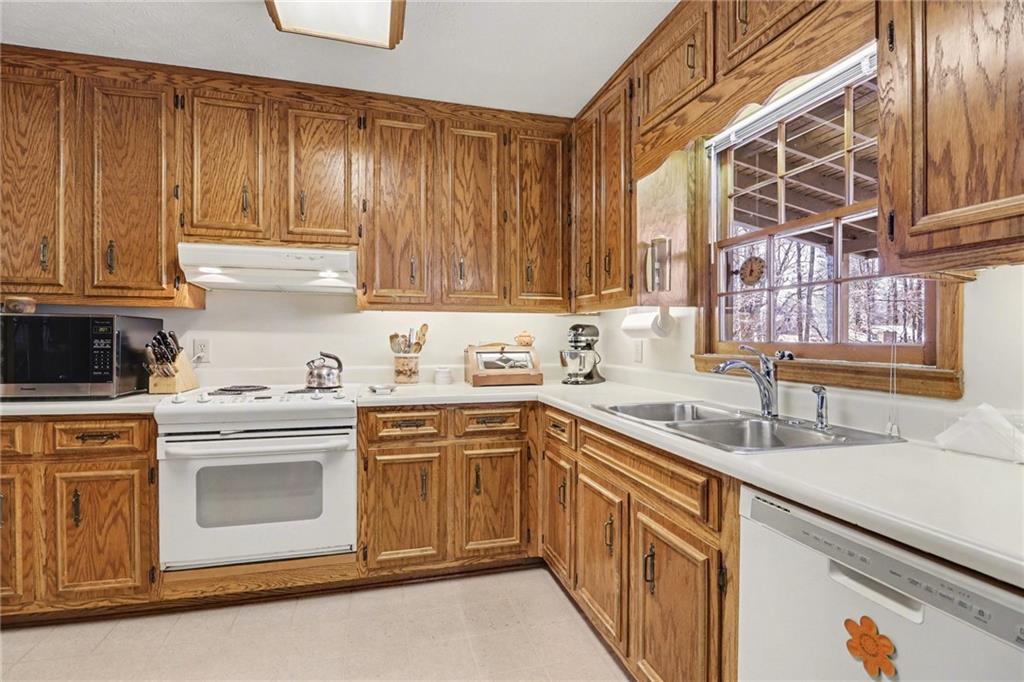 1940 Commonwealth Court Cumming, GA 30041 - Photo 10 of 29 a kitchen with a sink stove and cabinets