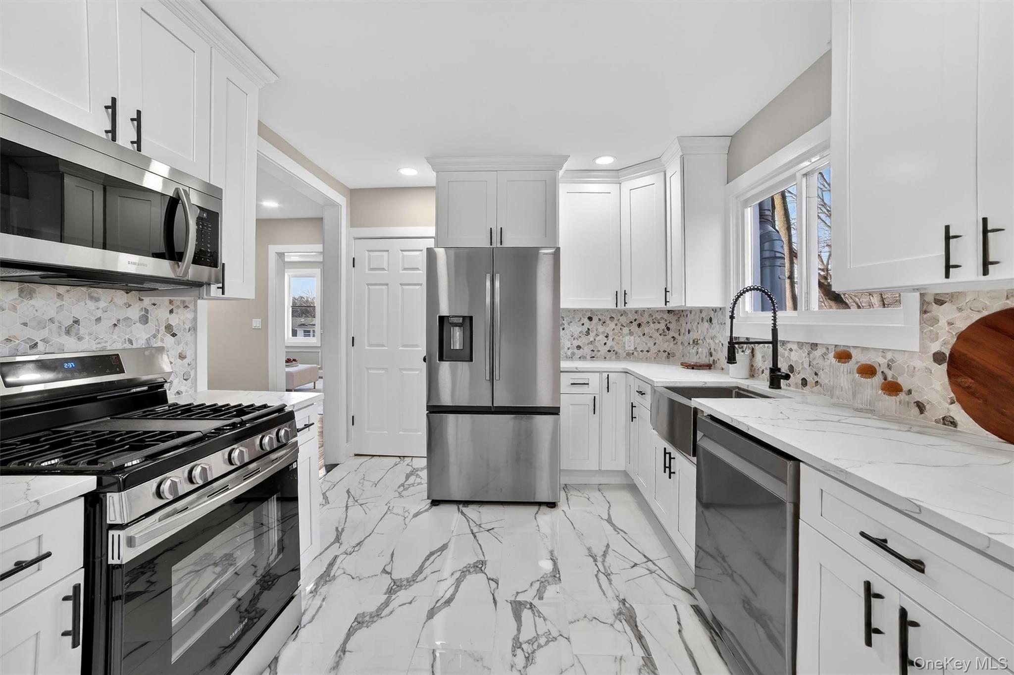 94 Jervis Road Yonkers, NY 10705 - Photo 13 of 50 a kitchen with stainless steel appliances granite countertop a stove refrigerator sink and microwave