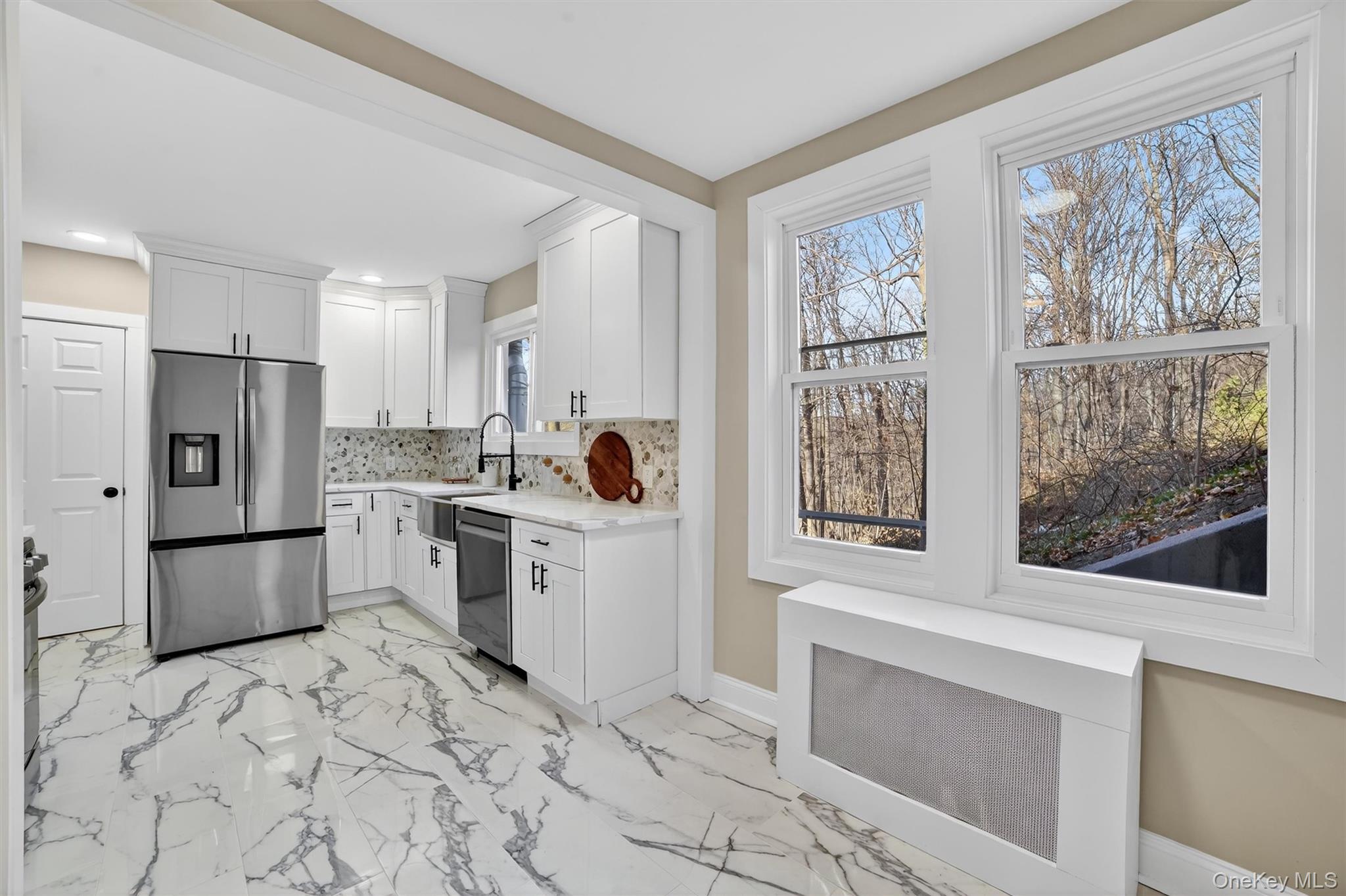 94 Jervis Road Yonkers, NY 10705 - Photo 17 of 50 a kitchen with a refrigerator and a stove top oven