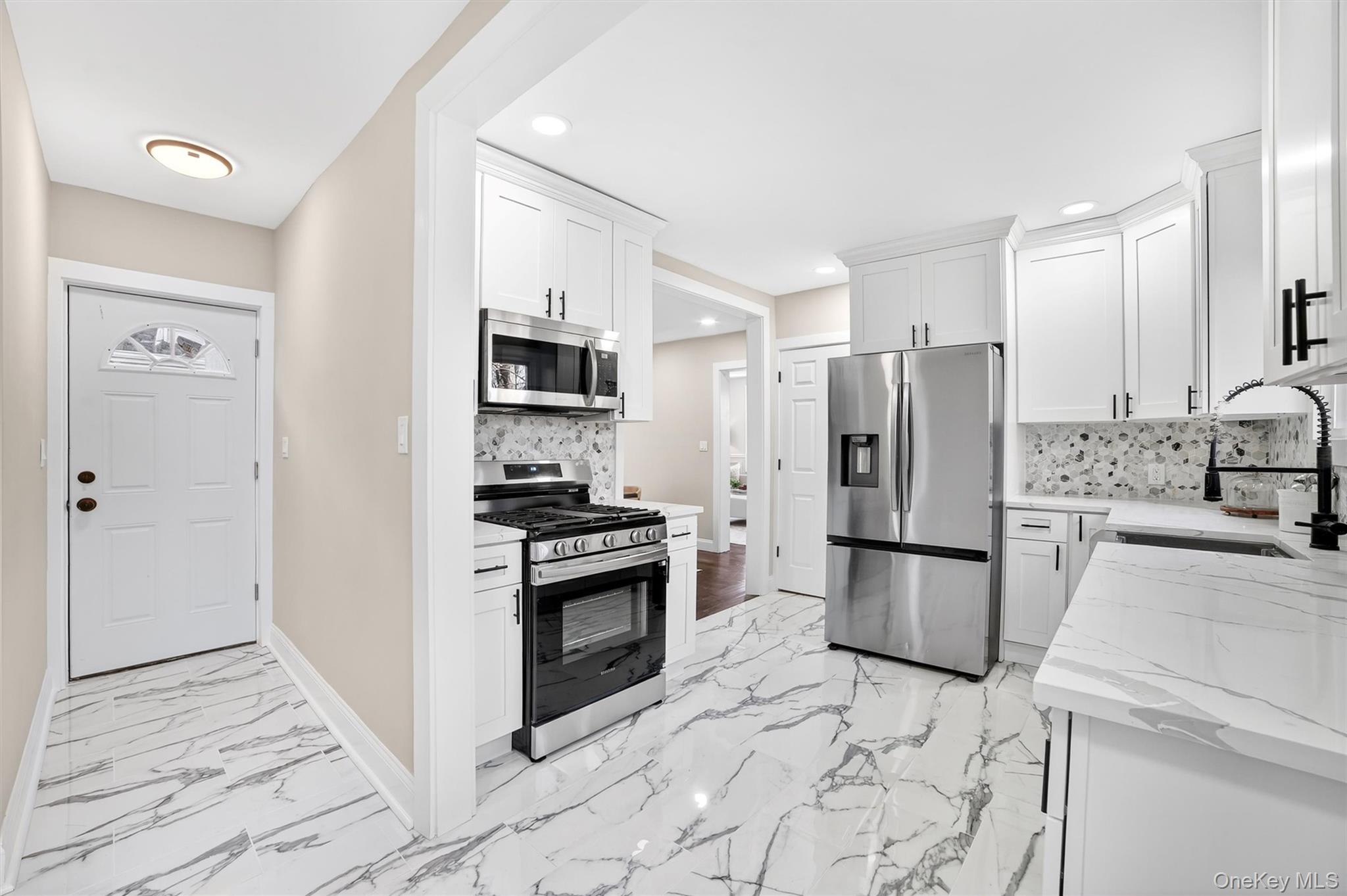 94 Jervis Road Yonkers, NY 10705 - Photo 19 of 50 a kitchen with granite countertop a refrigerator and a stove top oven