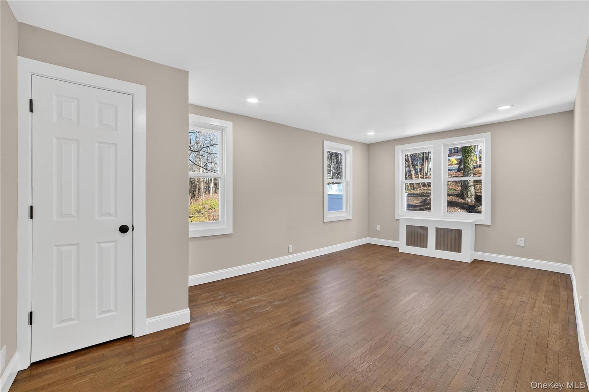 94 Jervis Road Yonkers, NY 10705 - Photo 24 of 50 a view of an empty room with wooden floor and a window