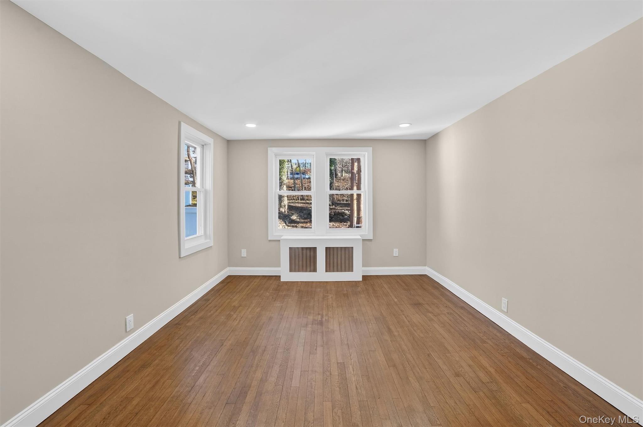 94 Jervis Road Yonkers, NY 10705 - Photo 25 of 50 an empty room with wooden floor and windows