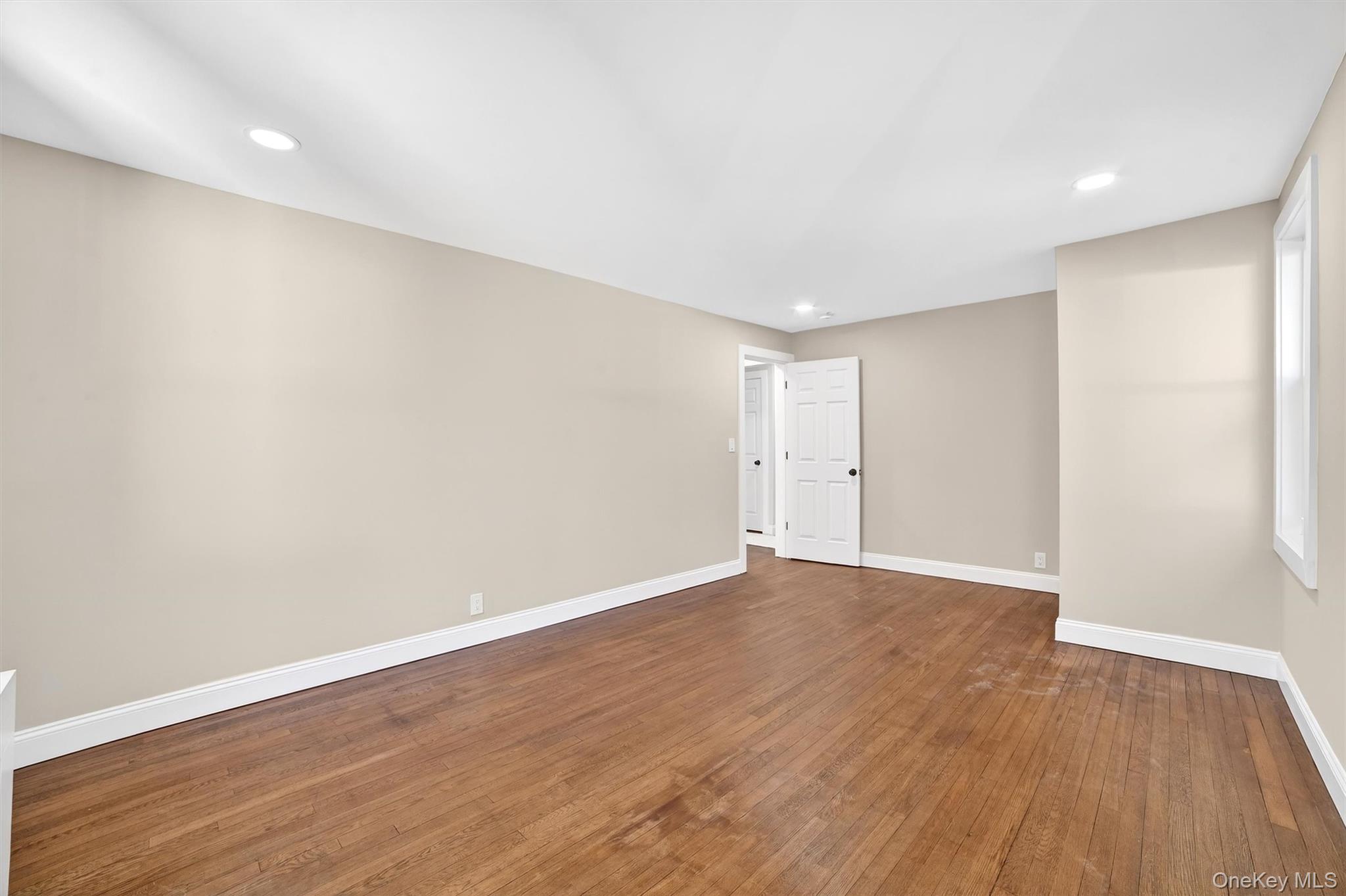 94 Jervis Road Yonkers, NY 10705 - Photo 26 of 50 a view of an empty room with wooden floor