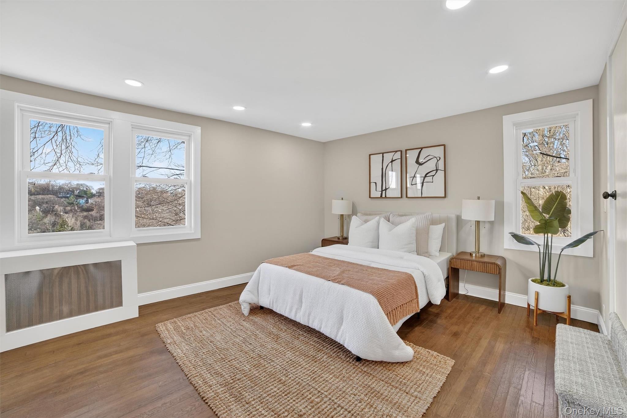 94 Jervis Road Yonkers, NY 10705 - Photo 31 of 50 a spacious bedroom with a large bed and a chandelier