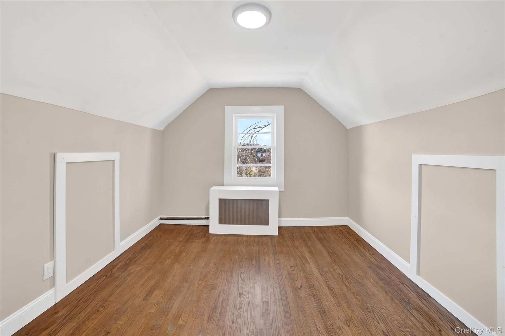 94 Jervis Road Yonkers, NY 10705 - Photo 36 of 50 an empty room with wooden floor cabinet and windows