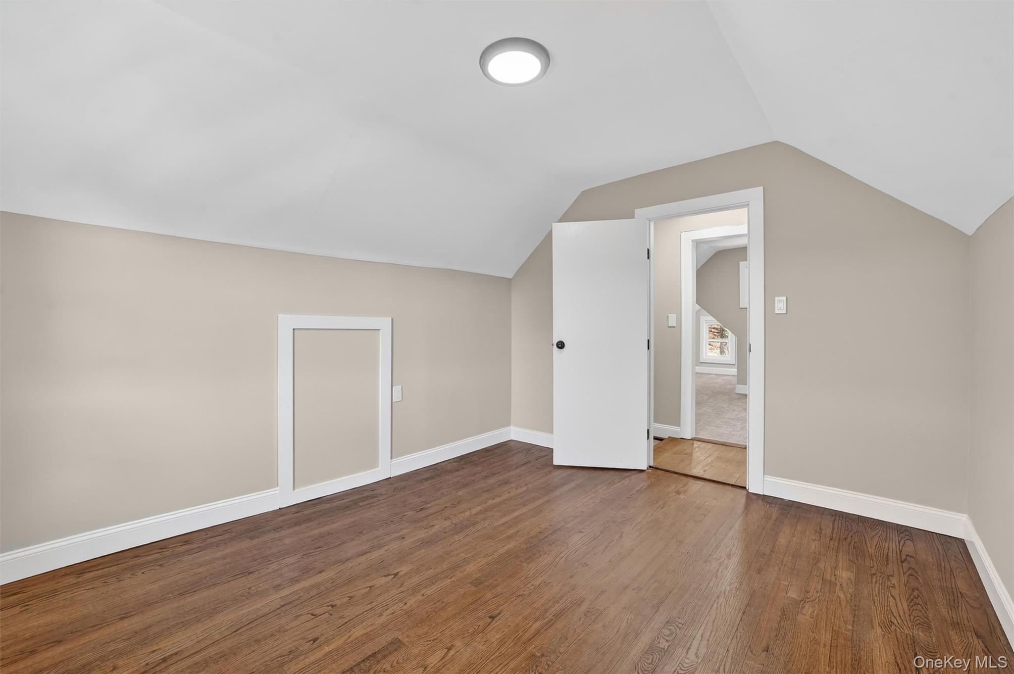 94 Jervis Road Yonkers, NY 10705 - Photo 37 of 50 an empty room with wooden floor and windows