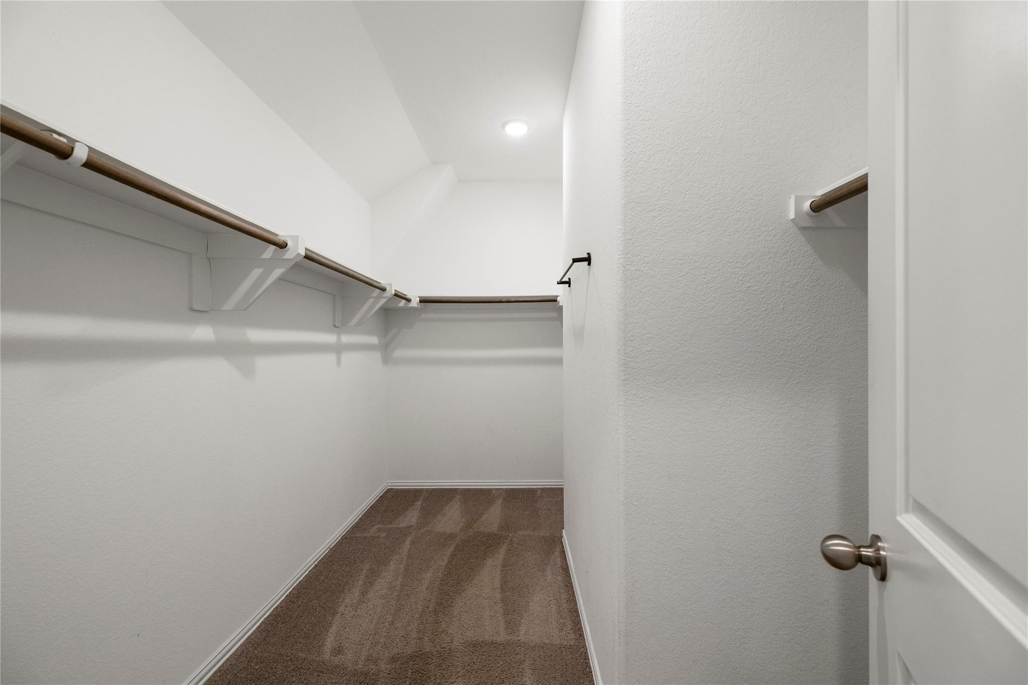 29507 Whitebrush Trace Drive Spring, TX 77386 - Photo 12 of 32 Walk-in closet with built-in shelving and hanging space.