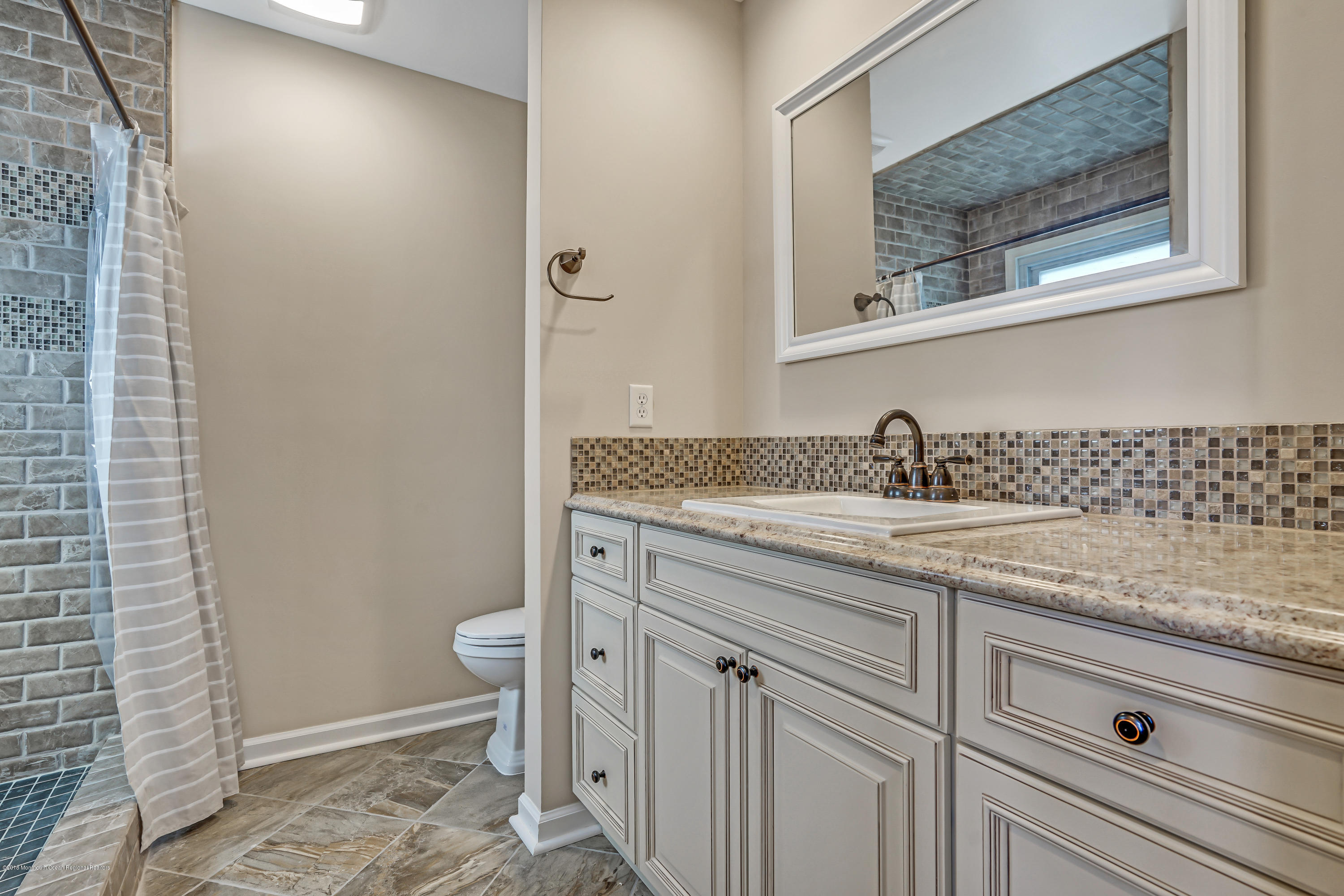 59 Marc Drive Howell, NJ 07731 - Photo 14 of 24 a bathroom with a granite countertop sink a toilet and a mirror