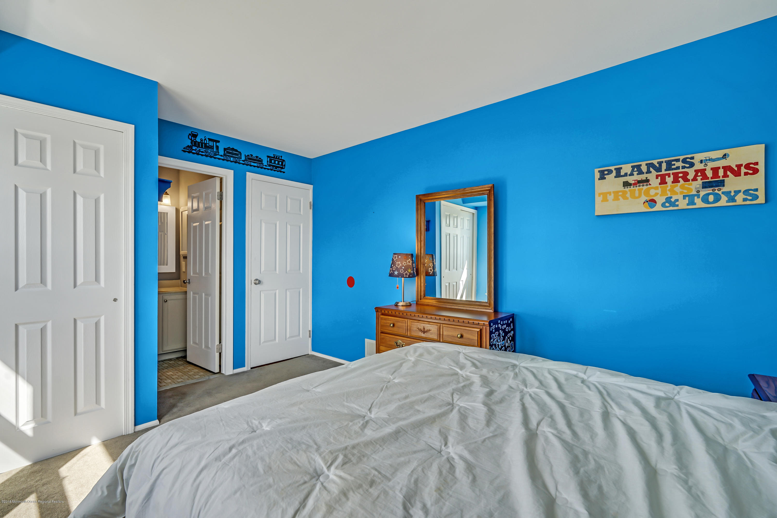 59 Marc Drive Howell, NJ 07731 - Photo 19 of 24 a bedroom with a bed and a lamp