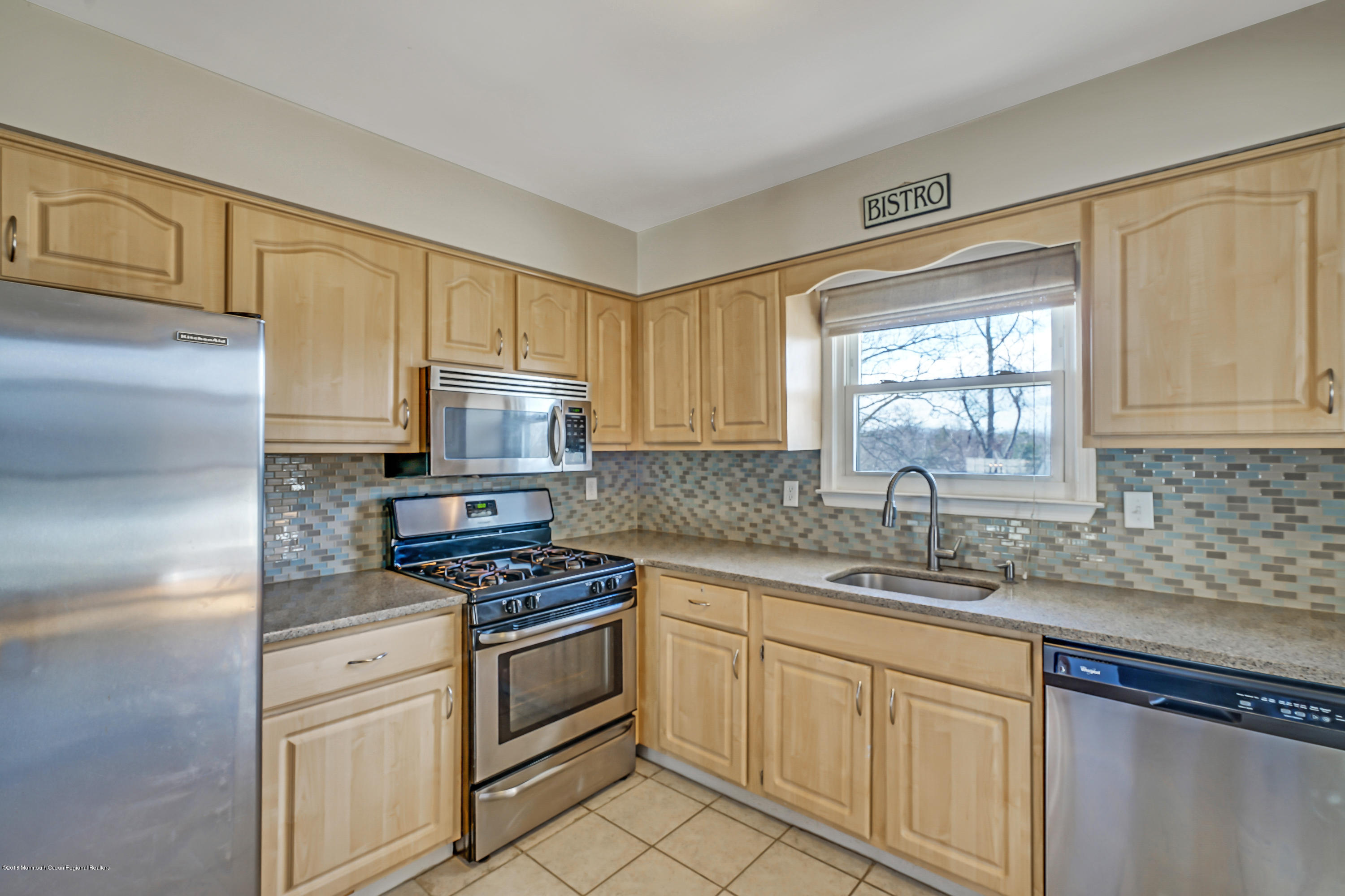 59 Marc Drive Howell, NJ 07731 - Photo 9 of 24 a kitchen with white cabinets sink and stainless steel appliances