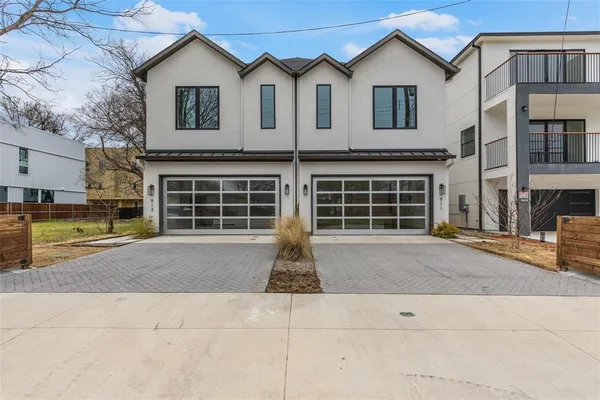 a front view of a house with a yard and parking space