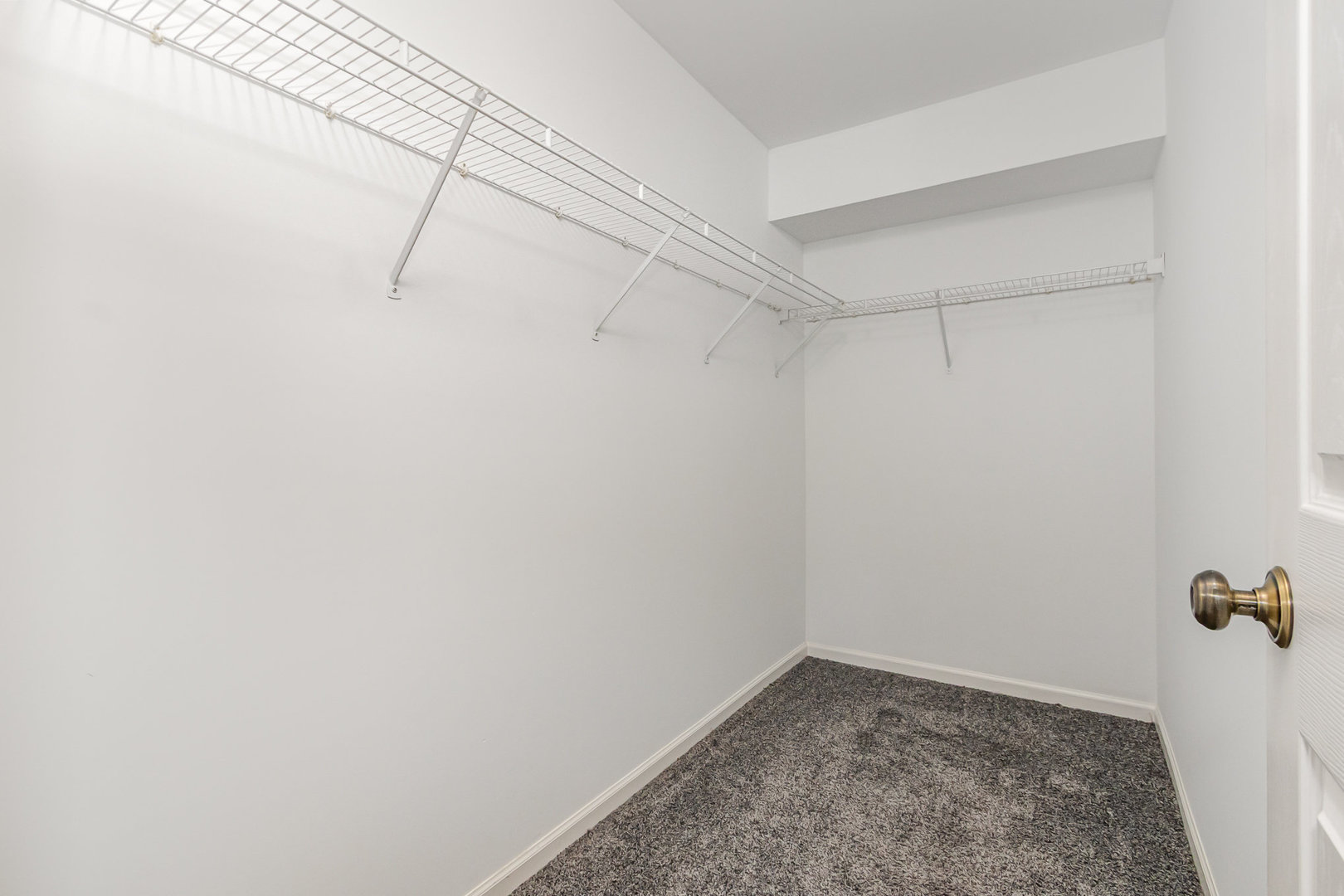 2211 Waterleaf Court, Unit 204 Naperville, IL 60564 - Photo 11 of 17 a view of a room with racks on the wall