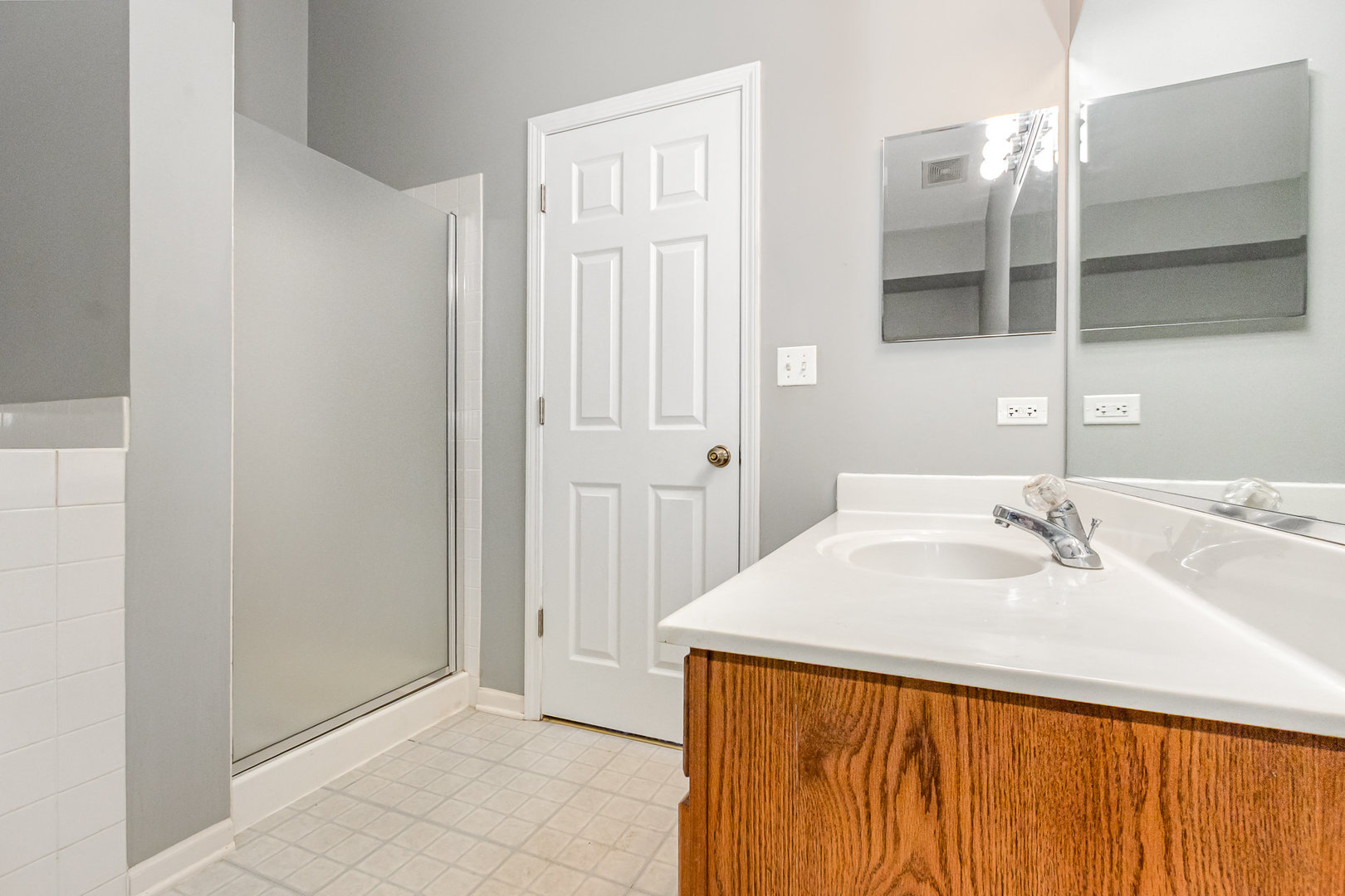 2211 Waterleaf Court, Unit 204 Naperville, IL 60564 - Photo 12 of 17 a bathroom with a sink and a mirror