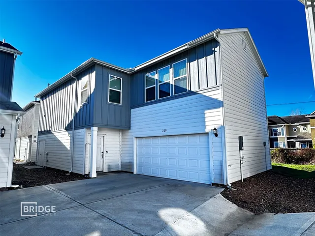 a front view of a house with a garage