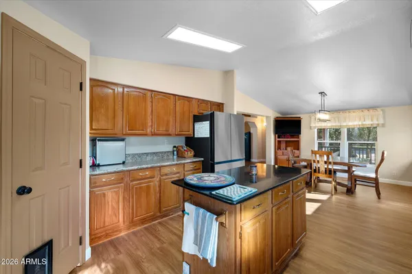 a kitchen with granite countertop a sink and a refrigerator