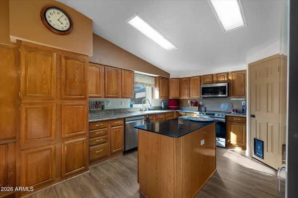 a kitchen with cabinets a sink and appliances