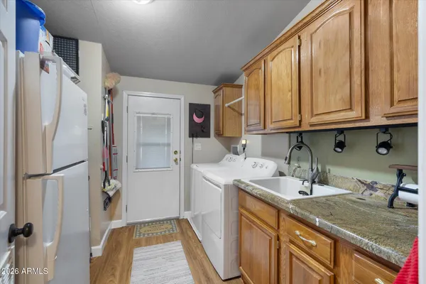 a kitchen with a sink a refrigerator and cabinets