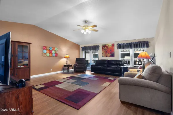 a living room with furniture a flat screen tv and a fireplace
