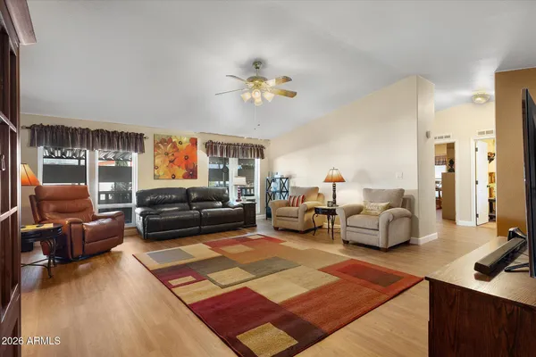 a living room with furniture ceiling fan and a rug