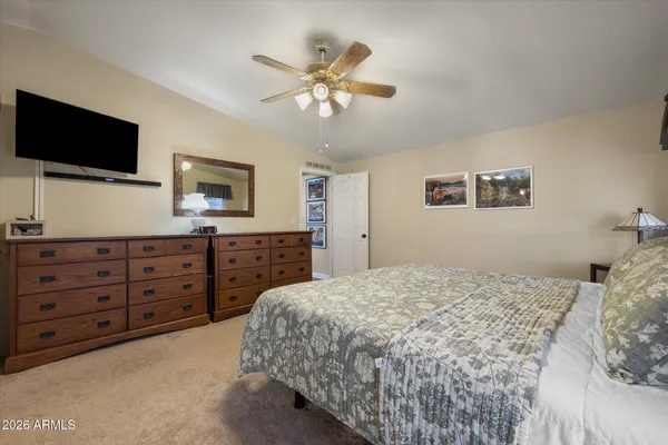 a bedroom with a large bed and a flat screen tv