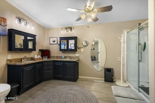 a spacious bathroom with a double vanity sink a mirror and a shower