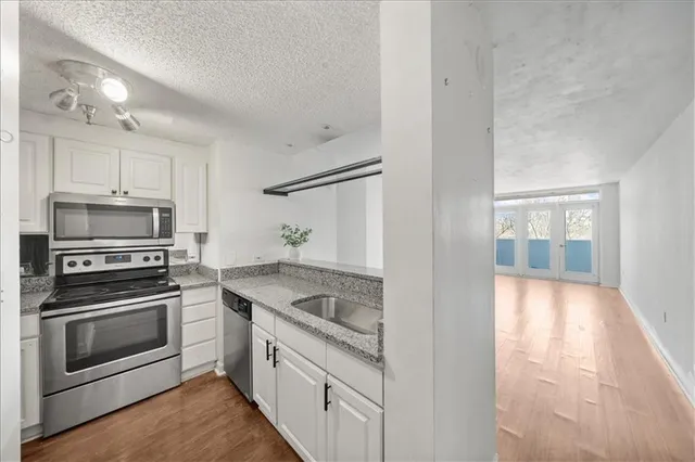 a kitchen with stainless steel appliances granite countertop a stove and a refrigerator
