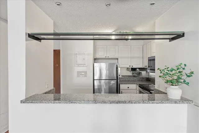 a kitchen with a refrigerator and a sink