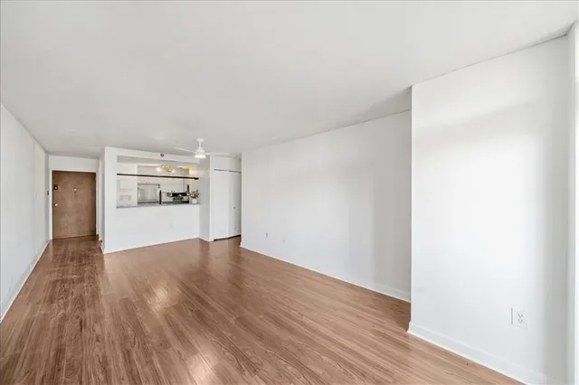 a view of empty room with wooden floor