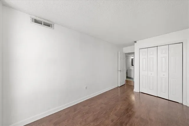 a view of a room with wooden floor