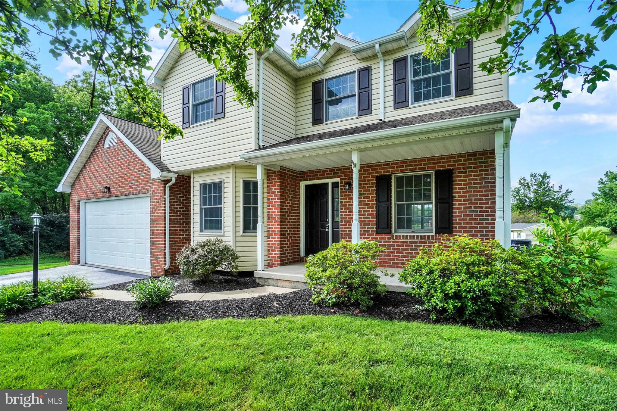 105 Margate Road York, PA 17408 - Photo 2 of 43 a front view of a house with a yard and potted plants