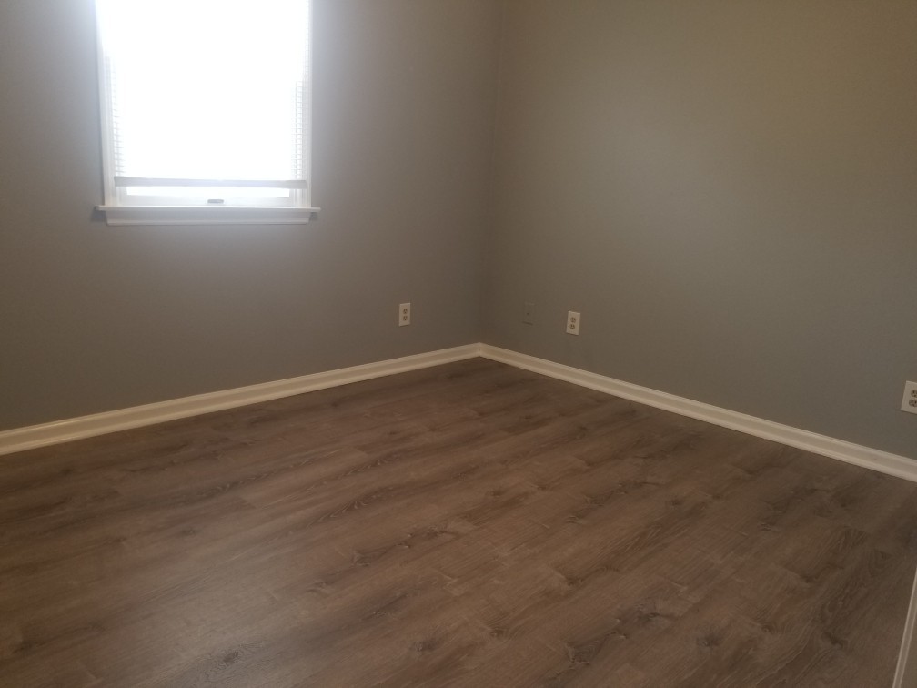 918 6th Street, Unit 3 LaSalle, IL 61301 - Photo 5 of 7 an empty room with wooden floor and windows