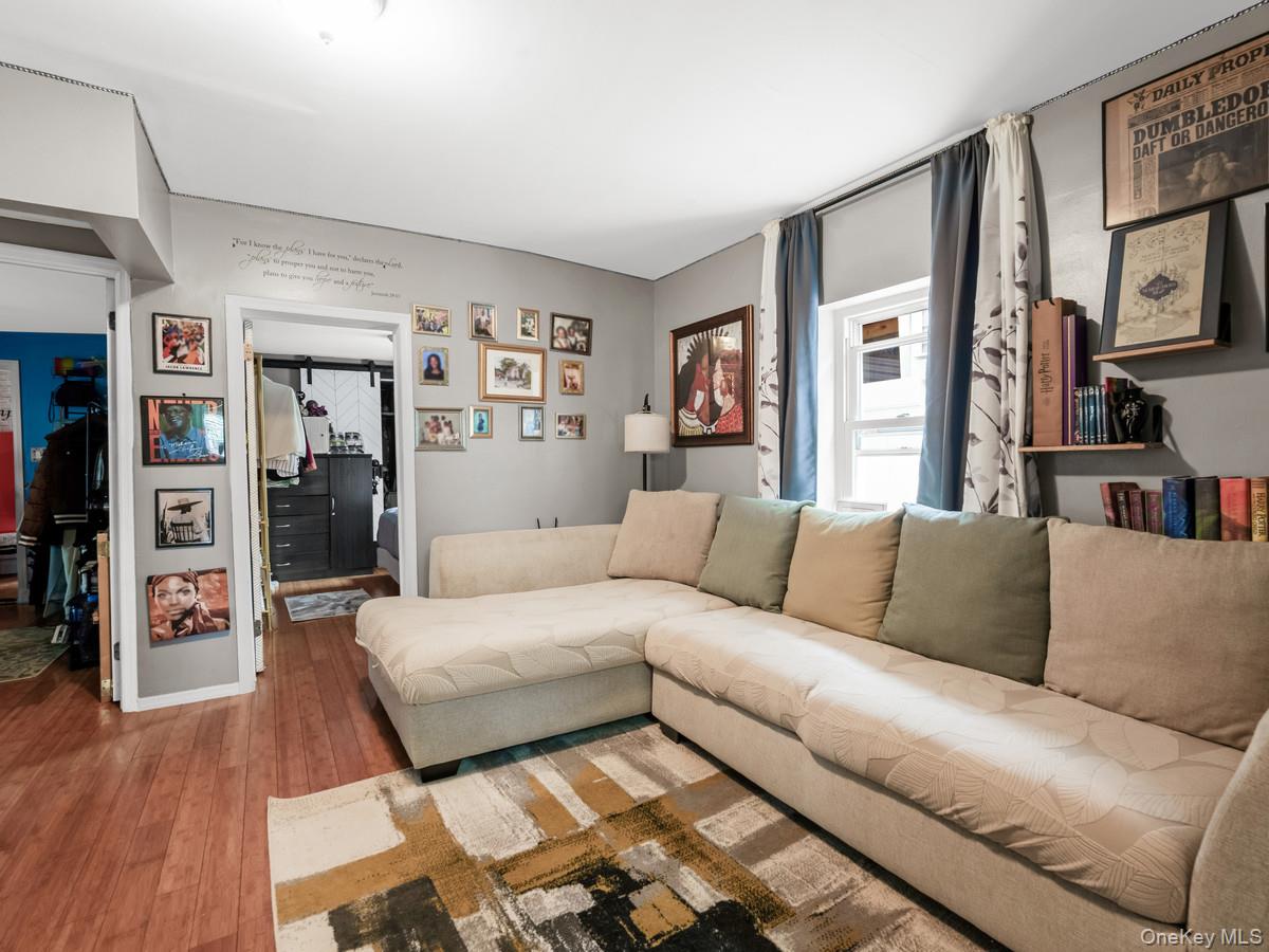 218-12 141st Road Queens, NY 11413 - Photo 2 of 14 a living room with furniture and a flat screen tv
